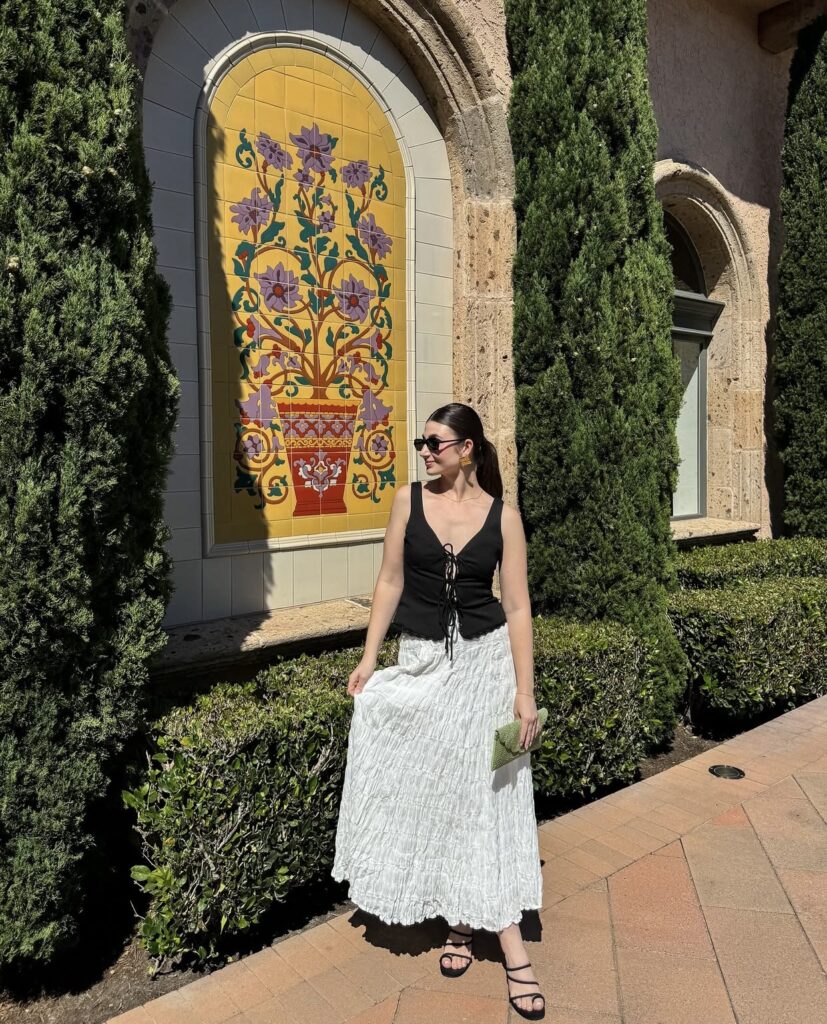 chic white maxi skirt with a black vest top and strappy sandals for a summer evening
