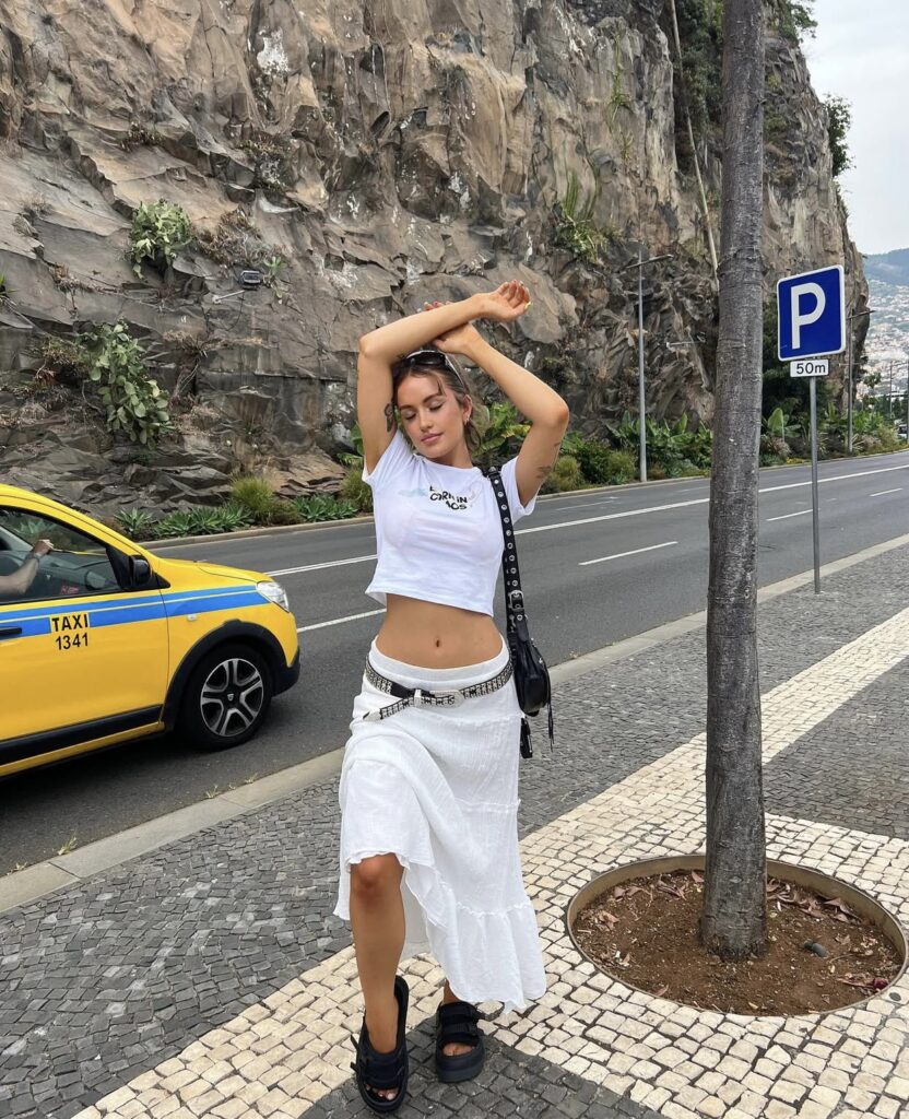 Pinteresty white low rise maxi skirt with a belt and baby tee styled with chunky sandals for summer