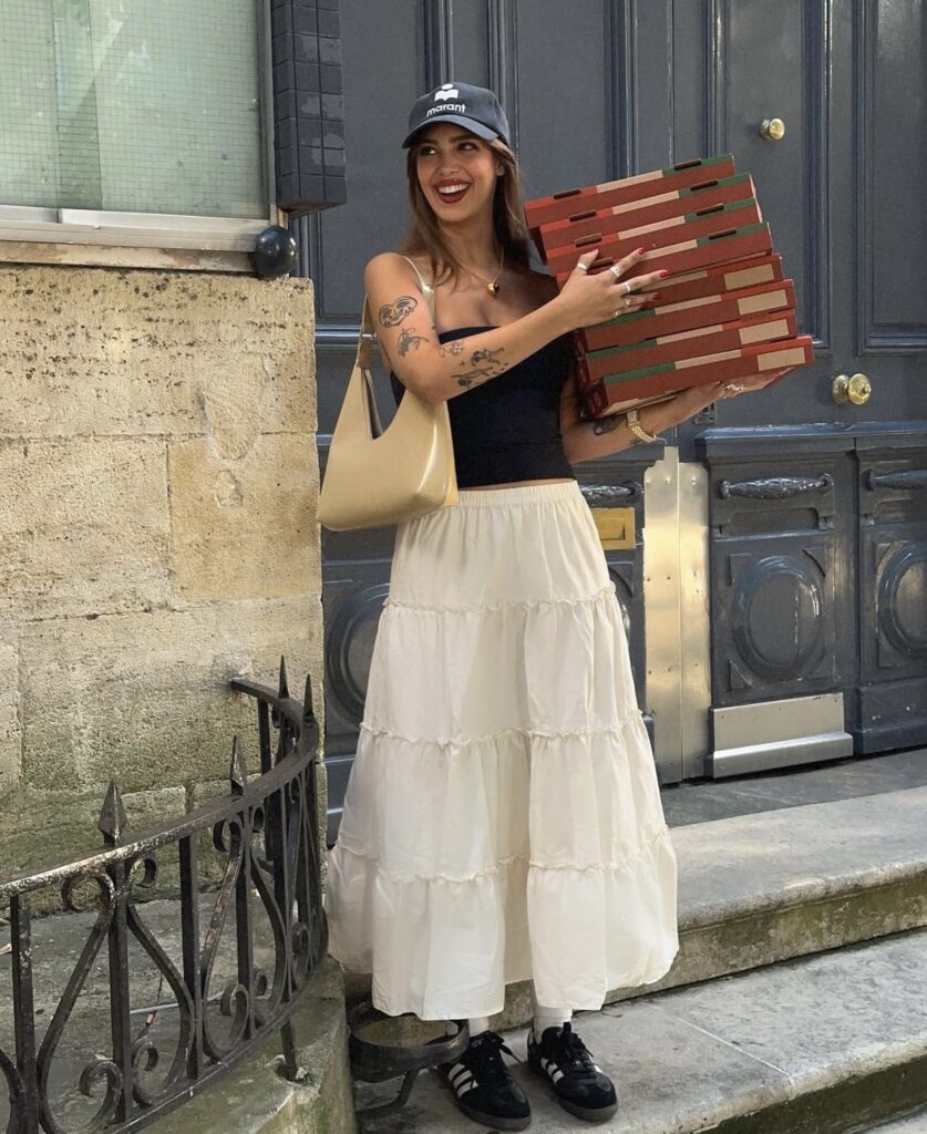 Cute white maxi skirt styled with a black top and cap for summer