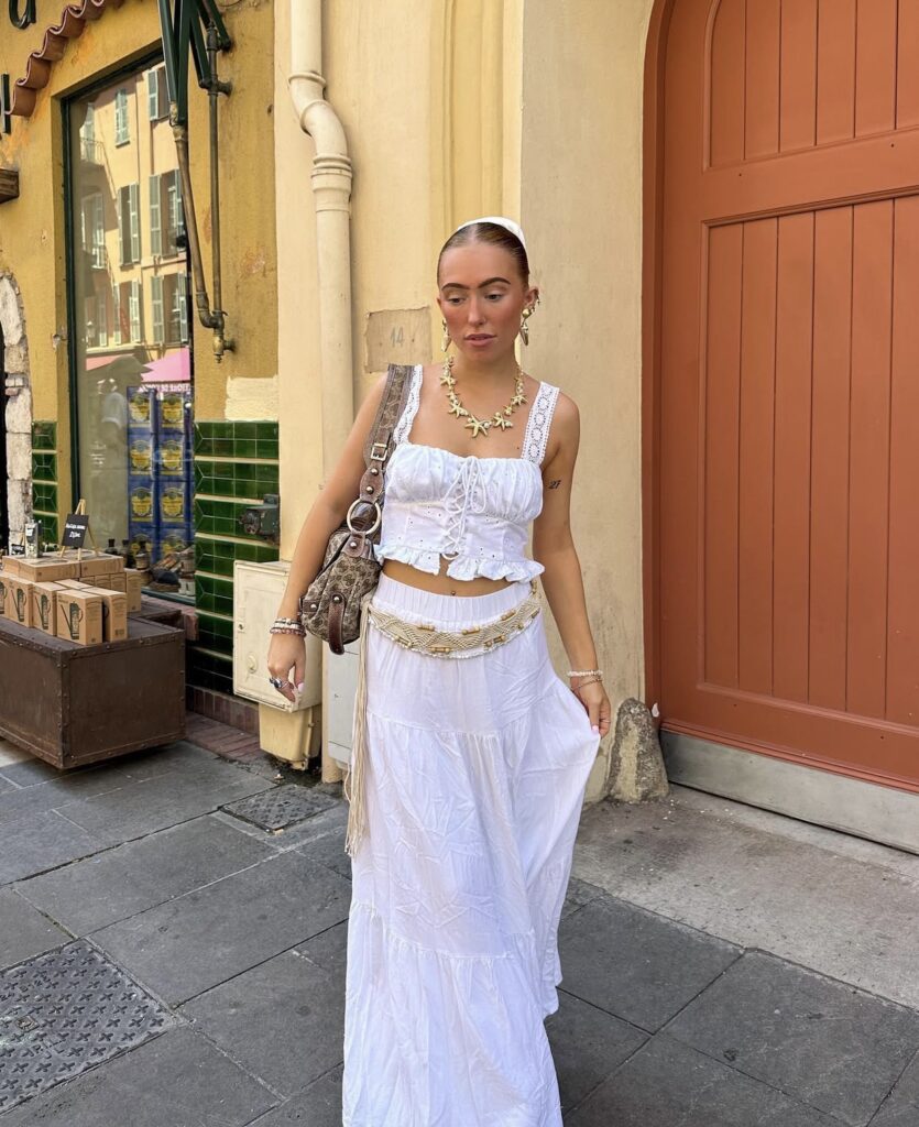 white maxi skirt with a boho belt and white top and a beachy necklace
